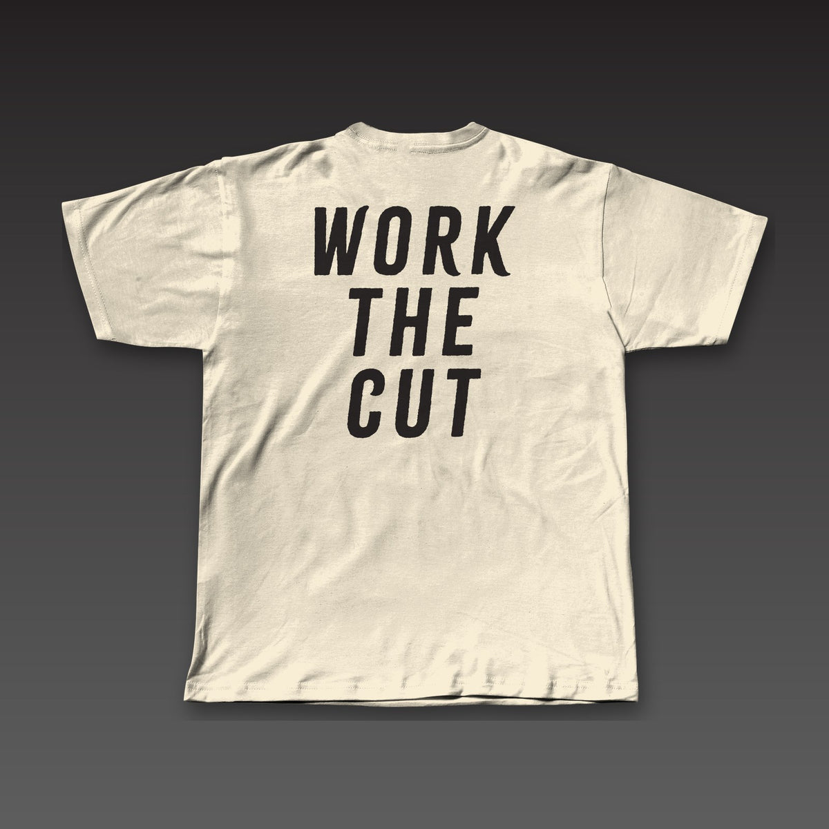 Fist Pocket Tee in oatmeal, Work the Cut stacked across the back